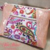 Stunning "Just Peachy" Sunshine Crossbody Crossbody. Measures 10 1/2" wise x 8" tall and 3" deep. $85.00 Colorful paisley floral fabric center, with striking holographic peach glitter vinyl. Rose gold hardware really ins striking in this combination. The exterior back also has a sipper pocket with rose gold zipper teeth and zipper pull. Matching adjustable strap in paisley and can be worn as a side strap or crossbody. Interior is waterproof canvas in rose gold color. It as a roomy slip pocket and zipper pocket.