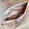 Stunning "Just Peachy" Sunshine Crossbody Crossbody. Measures 10 1/2" wise x 8" tall and 3" deep. $85.00 Colorful paisley floral fabric center, with striking holographic peach glitter vinyl. Rose gold hardware really ins striking in this combination. The exterior back also has a sipper pocket with rose gold zipper teeth and zipper pull. Matching adjustable strap in paisley and can be worn as a side strap or crossbody. Interior is waterproof canvas in rose gold color. It as a roomy slip pocket and zipper pocket.