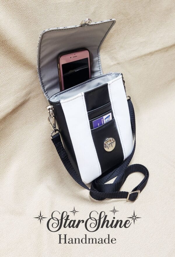 Black and White Snow Leopard Mini Mallory Crossbody. Upper Front View Showing interior with hidden cell phone pocket.