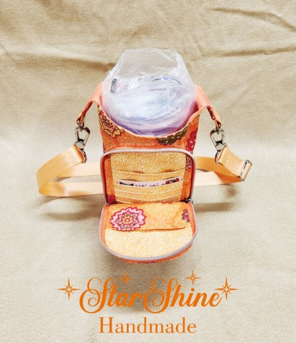 Full front view of Orange Floral Mandala H2o2Go Crossbody Bag showing front pocket.