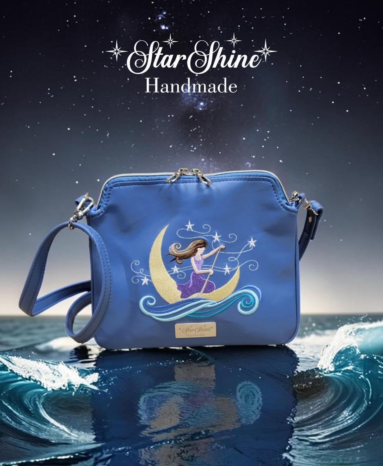 The Dreamer Small Blue Crossbody. Front view showing embroidered fantasy figure.
