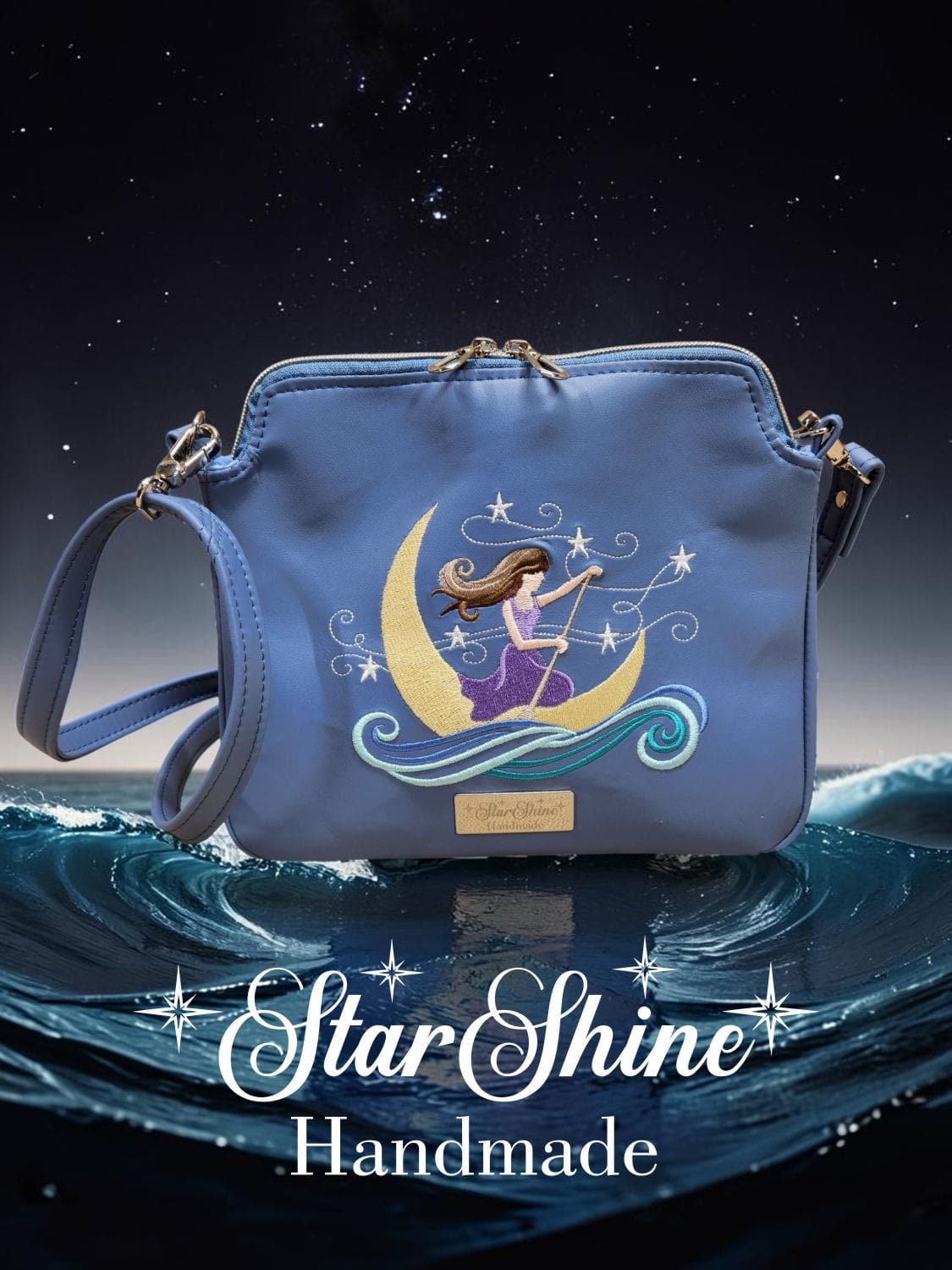 The Dreamer Small Blue Crossbody. Front view showing embroidered fantasy figure.